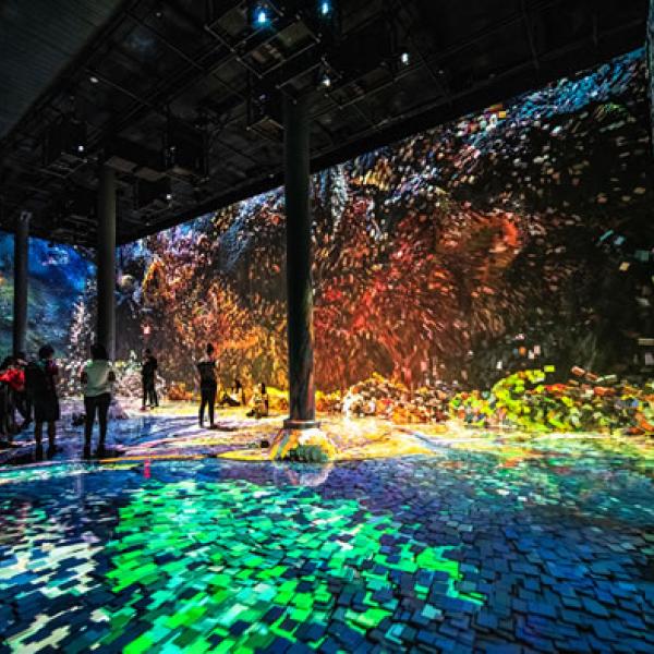 Multi-colored indoor visual projection installation taking up an entire gallery space